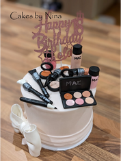 Cake decorated with makeup items for a birthday