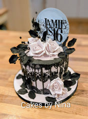 An 8" tall goth inspired cake with edible lace, piped lace detailing, sugar roses and sugar leaves and an handmade topper - £285.00