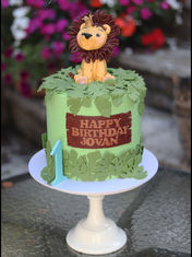 6" tall cake with a model of a lion on top