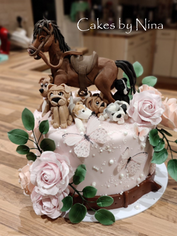 Cake decorated with horse, puppies, and flowers