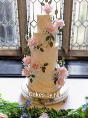 Wedding Cake - Horsley Towers - Stunning blush pink sugar roses, and soft blue tiny flowers, with dark green foliage on this beautiful wedding cake