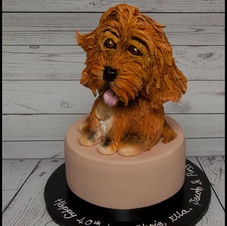 Dog-shaped cake on a black cake stand