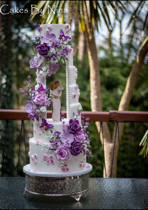 Luxury wedding cake Surrey, Hampshire and Berkshire - bespoke sugar flower wedding cake.  An award winning cake design in Surrey. Talking point wedding cake, with open arch, truly stunning wedding cake, romantic wedding cake, lots of sugar flowers in beautiful lilac and purples, cakes by nina, luxury wedding cakes, wedding cakes
