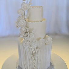 Elegant Modern White wedding cake with rice paper ruffles and fantasy rice paper florals