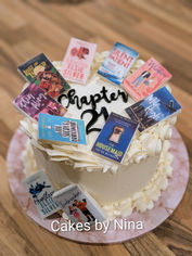 Buttercream finished cake with chapter 21 writing and lots of different edible books