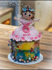 Handpainted whimsy birthday cake with an sugar doll on top