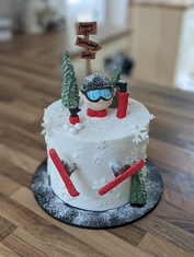 Skiing themed men celebration cake with snow and figurines
