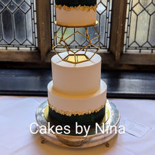 Beautiful hexagon elegant dark green and gold leaf wedding cake