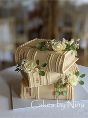 Book-shaped cake with floral accents by Cakes By Nina