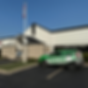 The image showcases the sleek, modern exterior of a commercial building freshly spray-painted by Eme