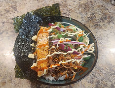 An image of a bowl of food containing salmon, dried seaweed, various vegetables, and stir fried mushrooms