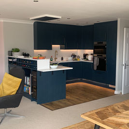 Stunning Modern Open Plan Kitchen Refurbishment, leading into spacious living room with ambient lighting. Beautiful Golden Hanging Ceiling Lights done by Collective Projects London, CPL