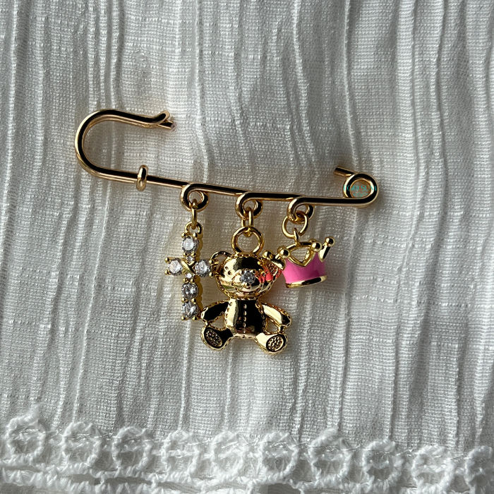 Delicate Catholic baptism pin designed as a baby blessing keepsake with pink crown