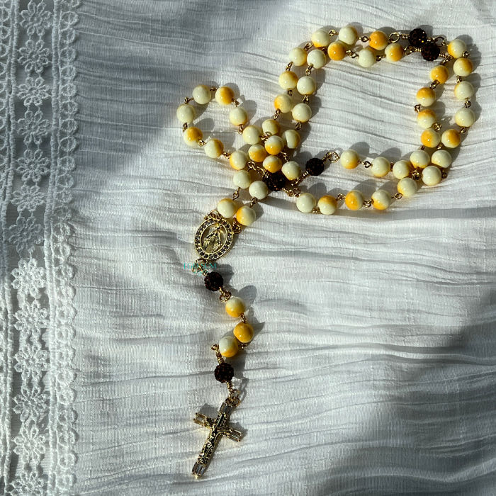 Catholic 5-decade rosary inspired by Saint Bernadette with soft cream and yellow tones