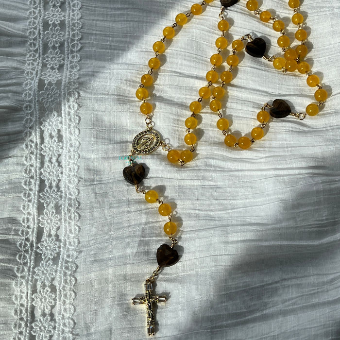 Catholic 5-decade rosary inspired by Saint Augustine with rich yellow tones