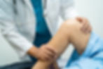 asian-doctor-physiotherapist-examining-massaging-treatment-knee-leg-senior-patient-orthope