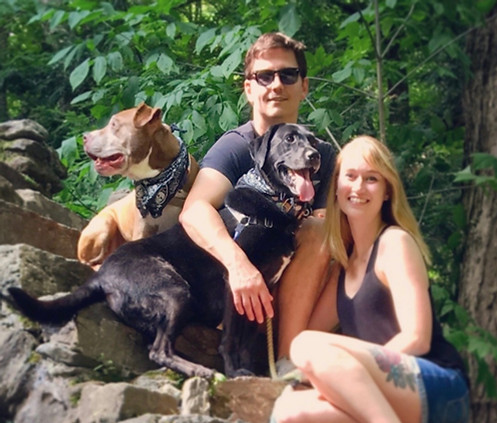 Two people and to dog in a family photo