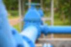 Water steel pipe close up image. Select focus of drink water piping with sluice gate. Flan