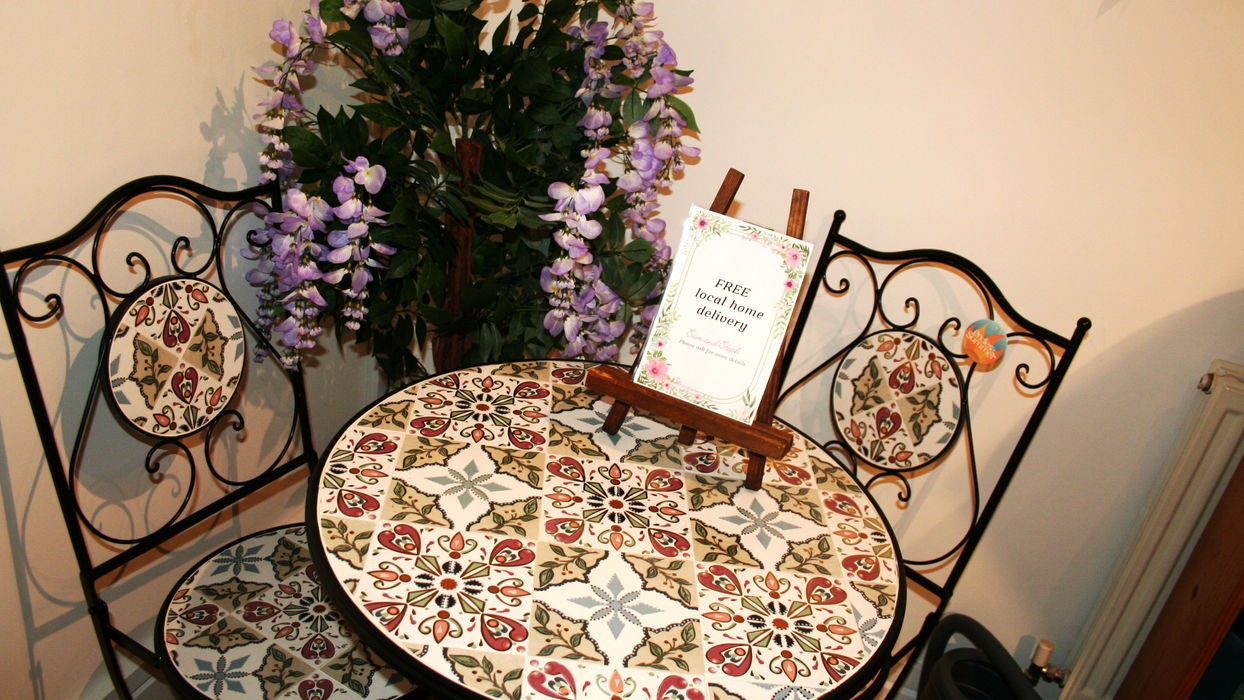black metal bistro set with floral tile pattern