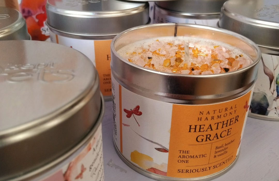 selection of scented candles in metal tins