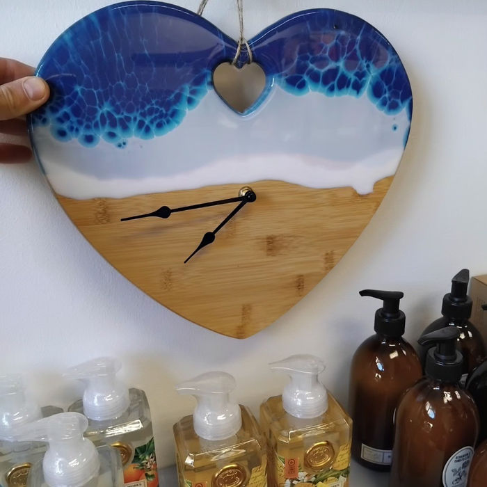 heart shaped wood and resin clock representing the incoming tide
