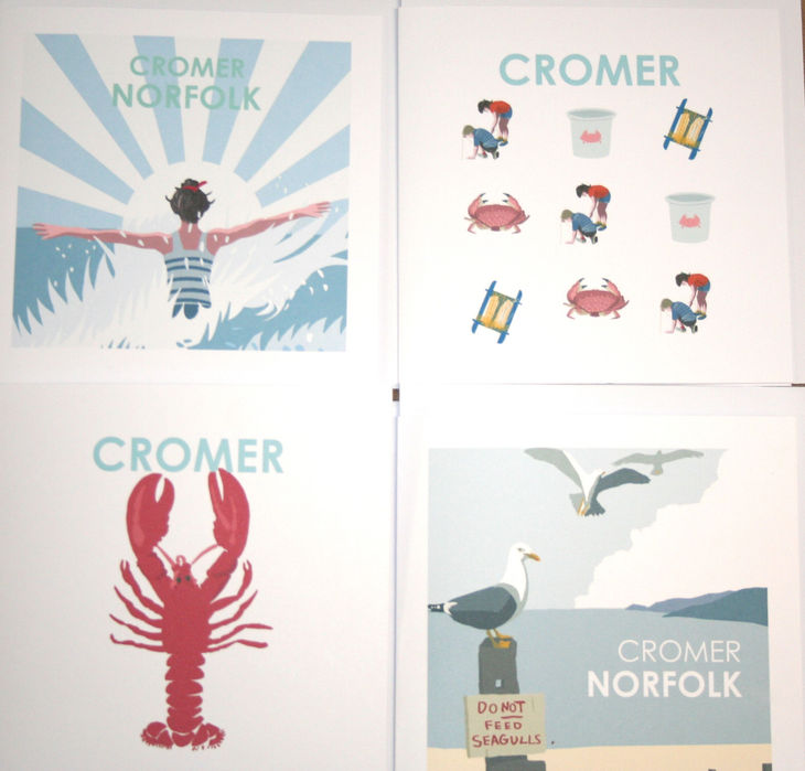 selection of greetings cards with designs relating to Cromer. Red lobster, crabs, seagulls, woman in striped bathing suit in the sea
