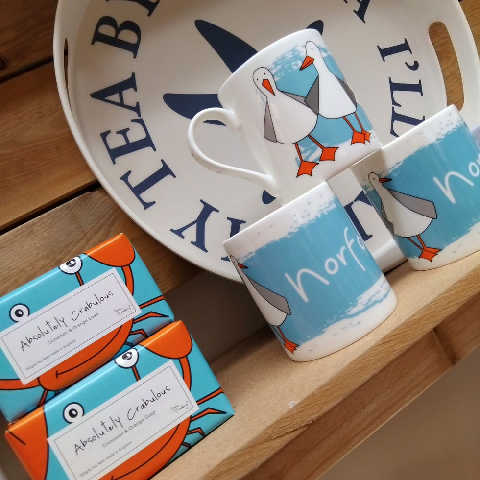 three china mugs, a round tea tray and bars of soap linked to the homewares section of the website