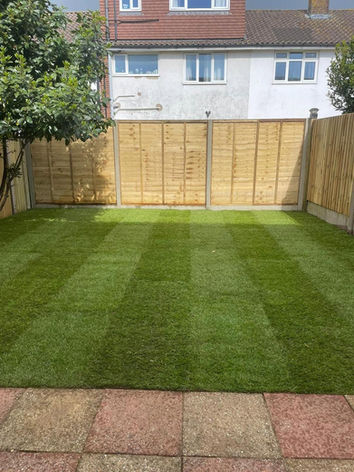 newly laid lawn enclosed by new close board fencing