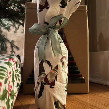 Wine bottle wrapped in a kitchen towel