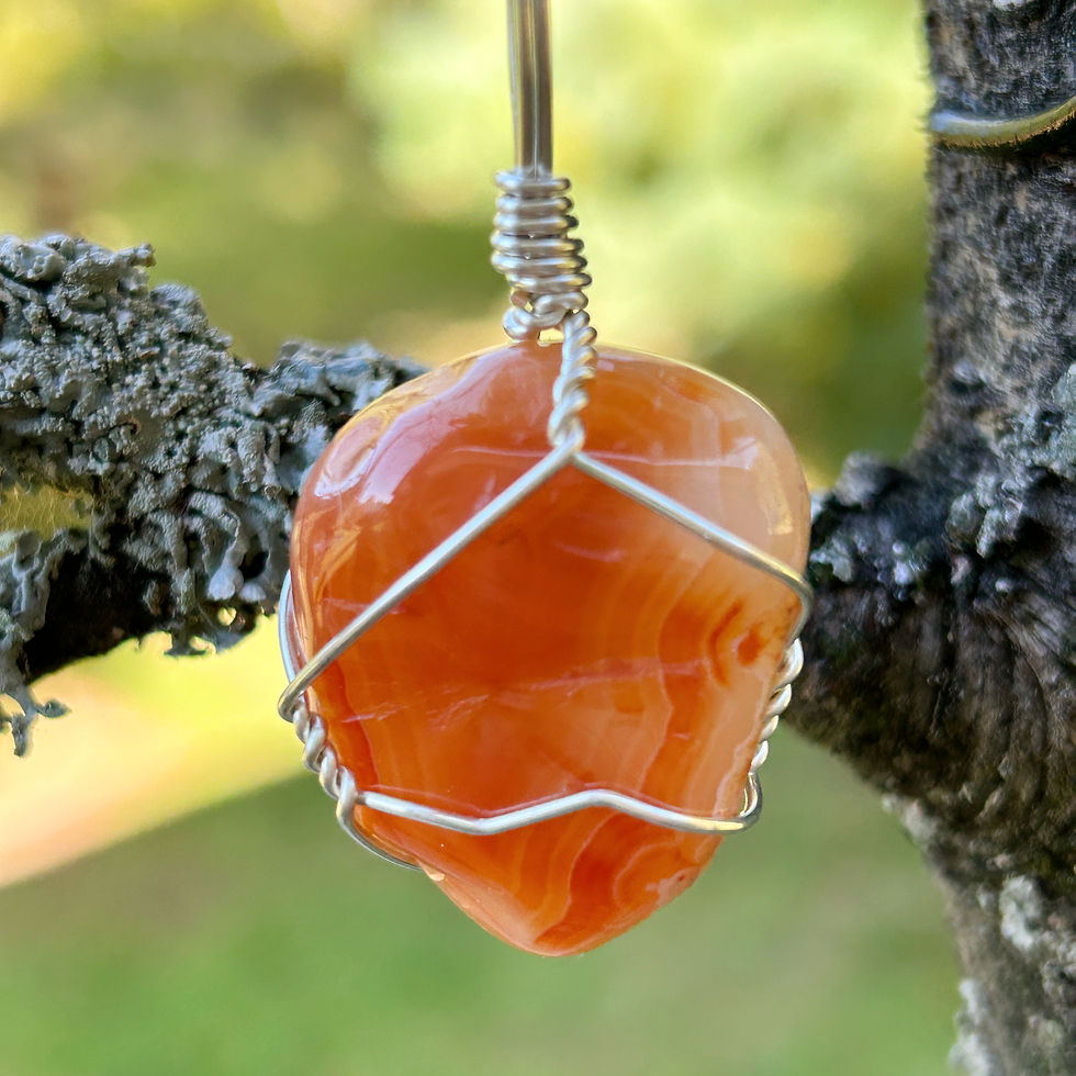 Thumbnail: Smooth polished Carnelian pendant with a small natural groove on the back