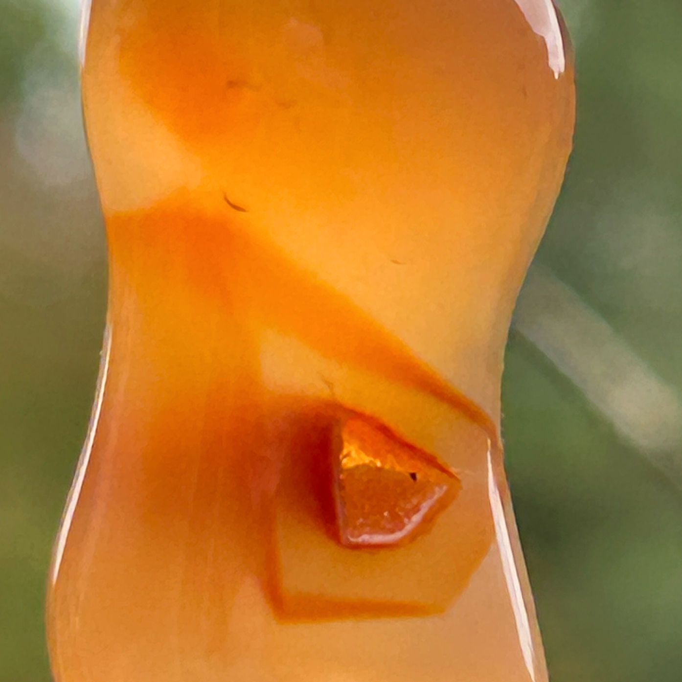 Carnelian pendant with sparkling crystal pocket inside the stone