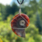 Your ammonite healing fossil jewelry in the sunlight so you can see the change of colour.  Handmade by Wicked Stones