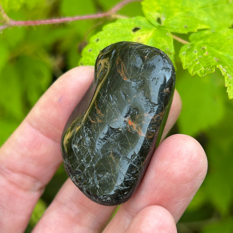 Palm-sized Black Tourmaline with curved edge and fine mineral streaks from Wicked Stones in Canada