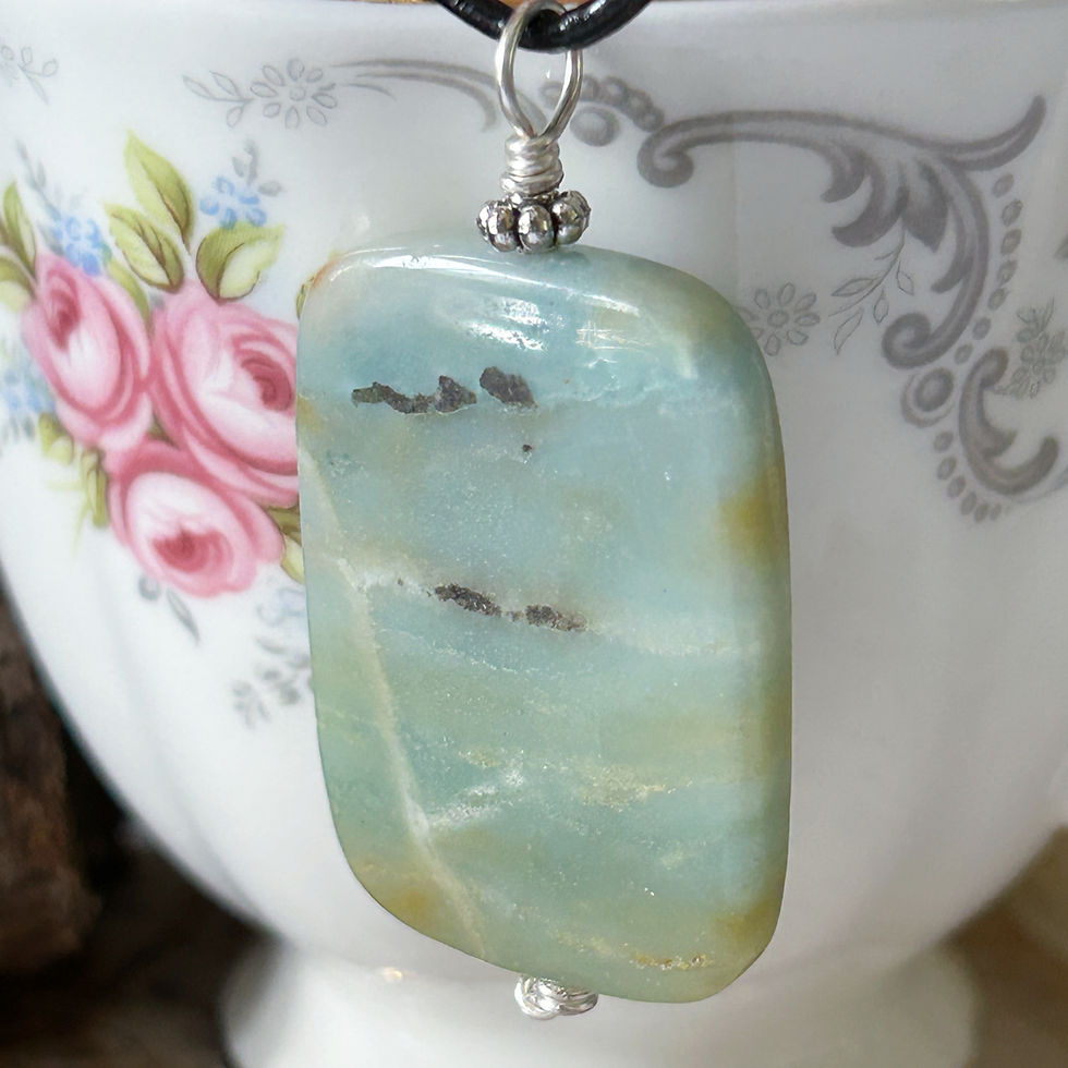 Smooth rectangular Amazonite pendant with rounded edges pendant made with silver wire and on a black cord necklace