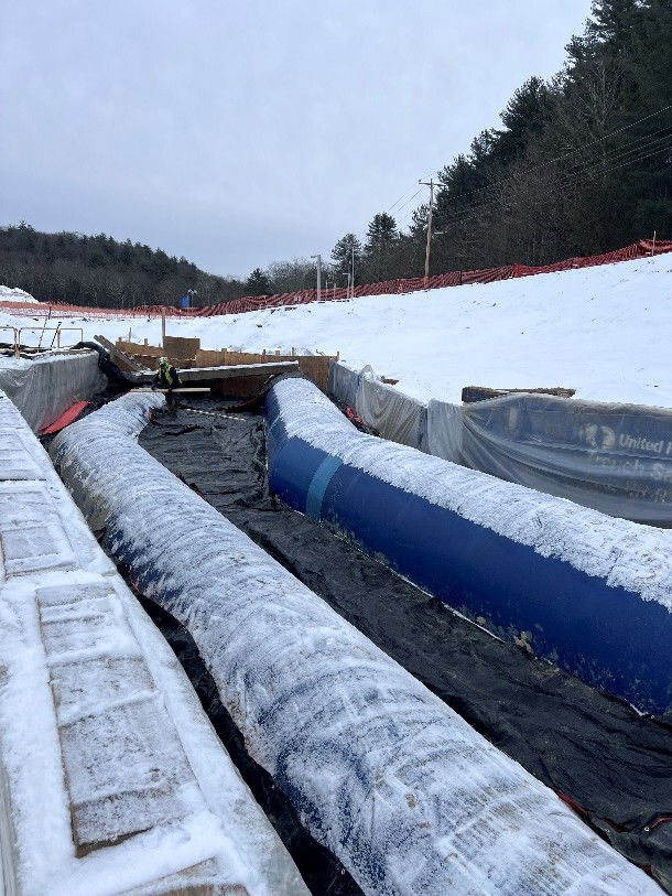 Black insulating blankets thaw the ground overnight.