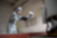 low-angle-man-spraying-powder-paint-from-gun.jpg