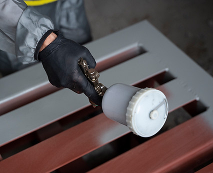 high-angle-worker-spraying-powder-paint-from-gun.jpg