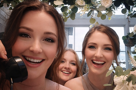 Guests having fun in the British telephone box video guestbook at a wedding