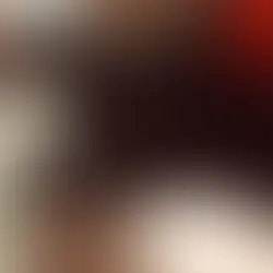 A cat laying on a person's arm