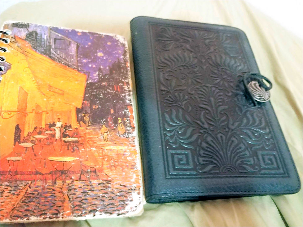 Notebooks resting on a bed