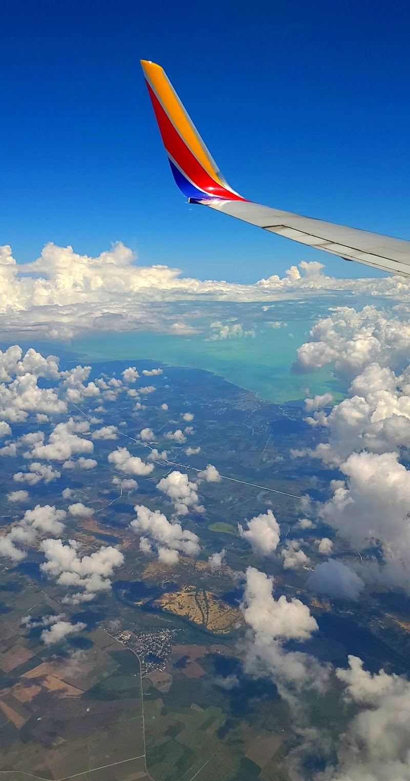 Plane Wing in Sky over Central America With Clouds in Sky