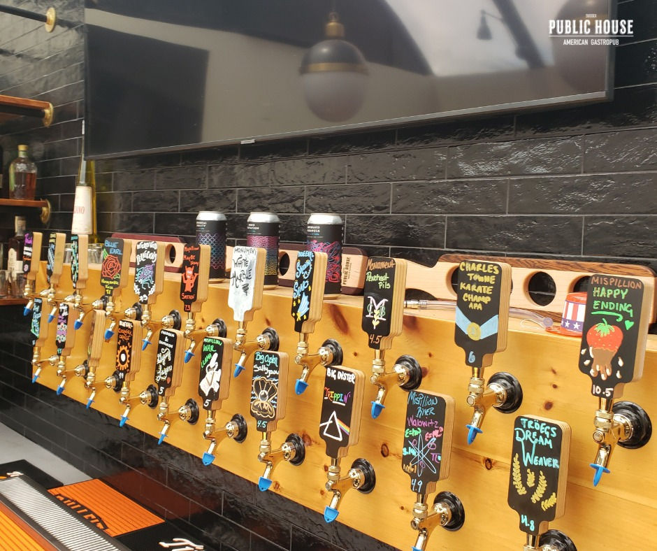 Chalkboard beer tap handles in a bar