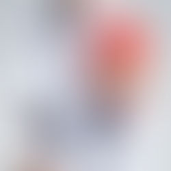 Person in a light blue shirt holding their upper arm, with a red highlighted area indicating shoulder or arm pain.