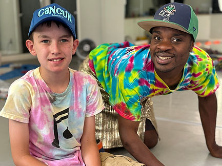 A volunteer and a camper smiling for the camera