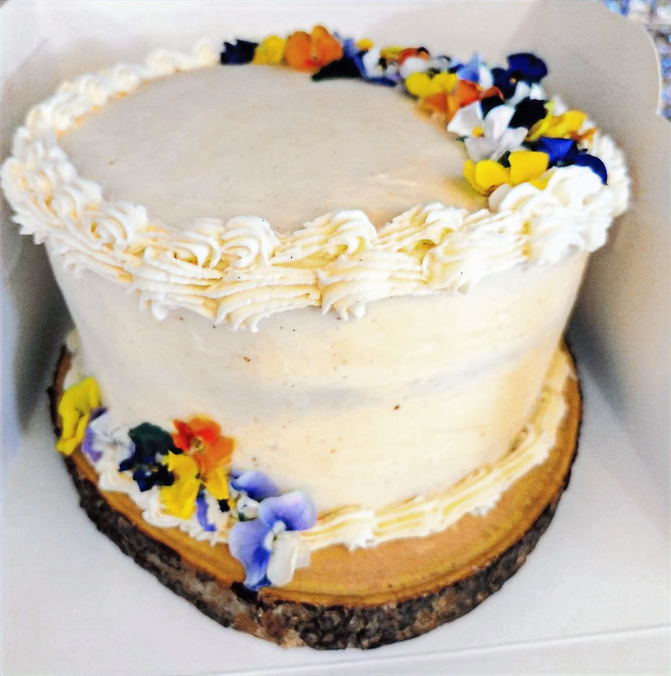 The Spicy Muffin Bar spiced Celebration Cake with vanilla buttercream and edible flowers
