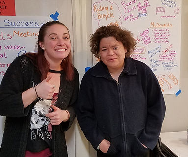 Two women in front of a Person Centered Plan.