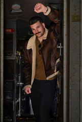 Full length portrait of male in faux leather jacket