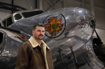 Portrait of male in front of old plane