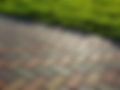 Colorful brick pathway next to green grass