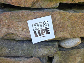 HD8 Life logo sticker, stuck to dry stone wall